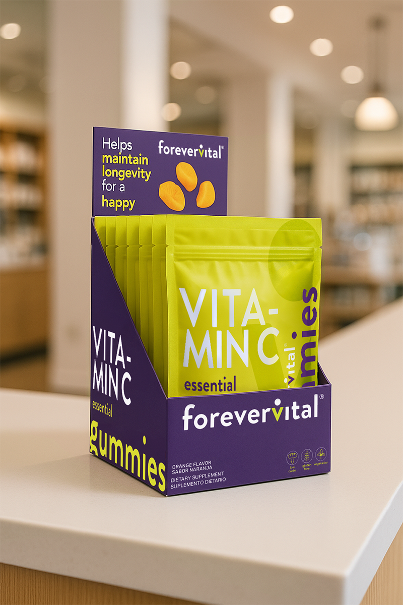Forevervital Vitamin C Gummies Dispenser x10 displayed on a retail counter, featuring 10 bright green pouches in a purple branded box.